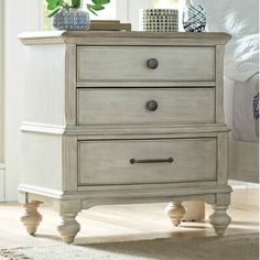 a white dresser with two drawers in a room