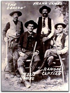 an old black and white photo of four men in cowboy hats sitting on a bench