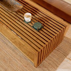 a wooden coffee table with a cup on it