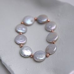 "Chic and classy Flat Pearl bracelet with rose gold spaces for her. Gift-redy. This pearl bracelet is very elegant and look so sophisticated on ladies hands. Could be matches with other jewelry or an elegant watch. Goes well for everyday style and could be a great gift for your friends and family. ✰ Wearing Pearls jewelry: Balance the human body's natural rhythms and hormones. Boosts inner wisdom and brings pure love. Helps to open up and find the meaning and your \"true self.\" Helps to imrpove Classy Flats, Wearing Pearls, Elegant Watch, White Pearl Bracelet, Pearl Gifts, Pearls Jewelry, Inner Wisdom, Flat White, Gift For Woman