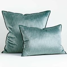 two green pillows sitting next to each other