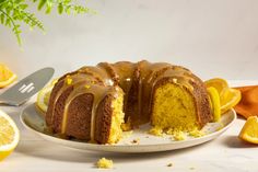 a bundt cake with lemon drizzled on it and sliced oranges