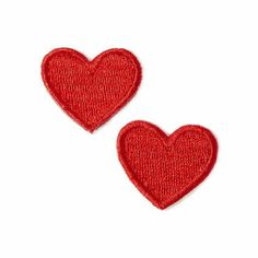 two red heart patches sitting on top of each other