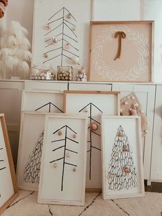 there are many framed christmas trees on display