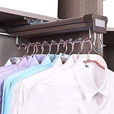 several shirts are hanging on the clothes rack