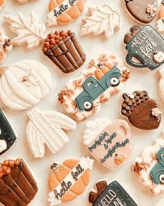 many decorated cookies are laying on the table together, including pumpkins and other decorations