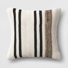 a black and white striped pillow sitting on top of a table