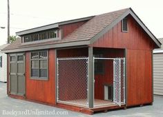 a small red building with a dog kennel attached to the front and side of it