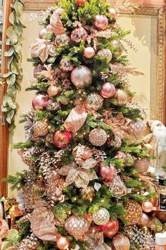 a christmas tree decorated with pink and gold ornaments