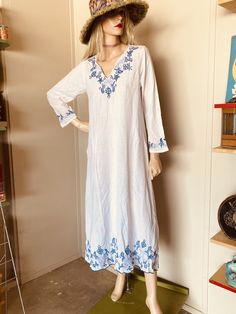 "I love this!! White cotton Blue embroidery Great condition Super light fabric Circa 1970's Measures: 36\" across chest 14\" shoulder to shoulder Hips 44\" Length 52\"" Casual Floral Embroidered Maxi Dress For Beach, Bohemian Chikankari Maxi Dress For Beach, Bohemian Maxi Dress With Chikankari Embroidery For Beach, White Vintage Dress For Vacation, Vintage Long Beach Dresses, Long Vintage Beach Dress, Vintage Long Dresses For The Beach, Vintage Tunic Dress For Vacation, Summer Beach Dress With Chikankari Embroidery