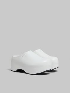 Chunky clog sabot with lightweight wooden platform sole, covered entirely in sleek nappa leather. Subtly embellished with debossed Marni lettering along the edge. Leather insole and ribbed rubber outsole. Modern Clogs With Rubber Heel Cap And Round Toe, White Platform Clogs With Closed Toe, Modern Synthetic Closed Toe Clogs, White Closed Toe Platform Clogs, Modern White Platform Clogs, Modern Leather Clogs With Reinforced Heel, Modern White Leather Clogs, Modern Synthetic Platform Clogs, Modern Leather Platform Clogs