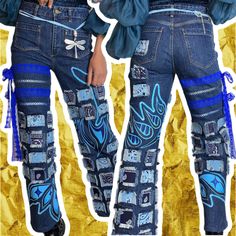 two women wearing blue jeans with designs on them