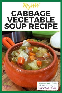 an orange bowl filled with vegetable soup on top of a wooden cutting board