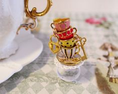 Tea Party Ring - Alice in Wonderland Ring - Teatime Ring - Harajuku Fashion -Miniature Food Jewelry -Kawaii Ring -Gift for Her -Teatime Ring This listing is for a very cute Alice Tea Party Ring with 3 lovely stacked teacups and lock and key displayed on a lovely white filigree base ring. This ring was inspired by the Alice in Wonderland story.  The base is about 1.5 inches tall (about 3 cm) the stacked cups are 4 cm - 1.5 inch high. the ring is adjustable. you will get exactly the same one as shown on the picture. some parts are not compatible with water (like paper labels and glue) and shouldn't be submerged. more Alice in Wonderland items here : https://www.etsy.com/il-en/shop/Dleesnow/search?search_query=alice&order=date_desc&view_type=gallery&ref=shop_search just keep away from little Wonderland Ring, Alice In Wonderland Accessories, Stacked Teacups, Kawaii Ring, Jewelry Kawaii, Alice Tea Party, Miniature Food Jewelry, Clear Plastic Bags, Food Jewelry