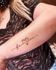 a woman with a tattoo on her arm that reads,'i love my family '