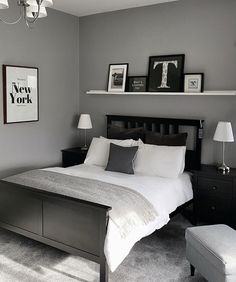 a bed room with a neatly made bed and two pictures on the wall above it