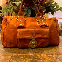 Francesco Biasia 1977 Vintage Handle Bag. Leather Antiqued Gold Tone Hardware Rolled Handles Vintage Condition With Leather Wear. Orange Leather Shoulder Bag With Gold-tone Hardware, Orange Tote Shoulder Bag With Gold-tone Hardware, Orange Leather Bags With Branded Hardware, Orange Satchel Shoulder Bag With Gold-tone Hardware, Designer Orange Leather Shoulder Bag, Orange Shoulder Bag With Branded Hardware For Travel, Travel Shoulder Bag With Branded Hardware In Orange, Orange Satchel With Gold-tone Hardware For Shopping, Orange Satchel With Gold-tone Hardware For Travel