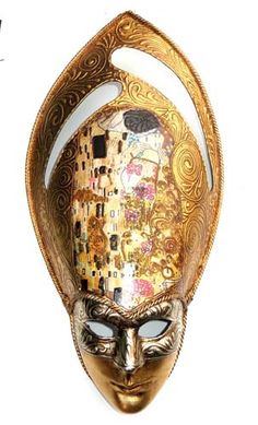 a gold mask with an artistic design on it