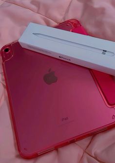 two new ipads are sitting on top of each other, one is red and the other is pink