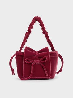 If you are looking to add a pop of colour to your look, this elegant pink top-handle bag is a sensible choice. It features a simple, classic pouch silhouette that allows the design details -- including the ruched handle and dainty bow embellishment -- to shine. Carry it by hand for a polished look or tuck it under the arm for hands-free convenience. You can always count on the velvety soft finish to complete your look with sophistication. Feminine Evening Bag With Top Carry Handle, Feminine Evening Bag With Removable Pouch, Elegant Pink Pouch Bucket Bag, Evening Pouch Box Bag, Feminine Evening Pouch Shoulder Bag, Elegant Pink Bucket Bag With Double Handle, Chic Pink Bucket Bag For Evening, Chic Pouch Box Bag With Handles, Feminine Shoulder Bag With Removable Pouch For Party