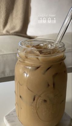 a glass jar filled with ice cream on top of a table