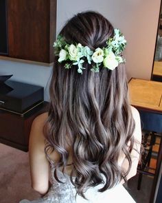 a woman with long hair and flowers in her hair