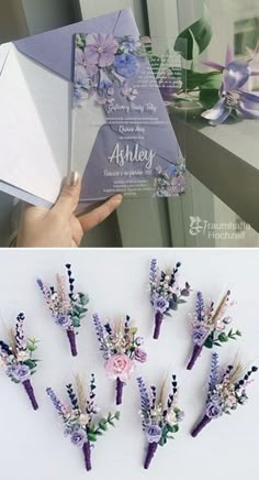 the wedding card is being held up to show it's beautiful flowers and foliage