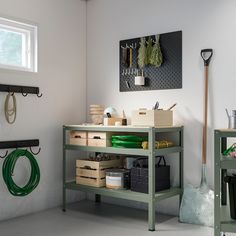 a workbench with lots of tools and supplies on the shelves next to it