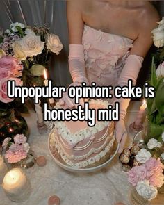 a woman in pink dress standing next to a cake