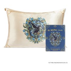 the harry potter pillow and book are shown in front of a white background with blue flowers