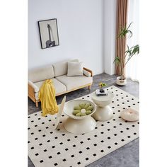 a living room with white furniture and black and white rugs on top of the floor