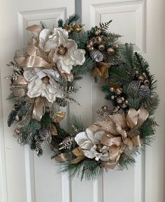 a christmas wreath hanging on the front door with pine cones and other holiday decorations around it