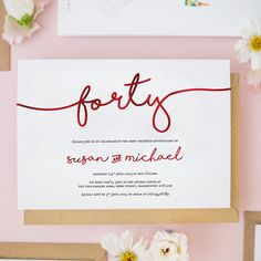 the wedding stationery is displayed with flowers