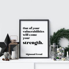 a white shelf topped with christmas decorations and a framed poster