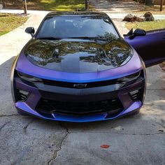 the front end of a purple sports car