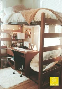 a bunk bed with a desk underneath it in a room that has hardwood floors and white walls