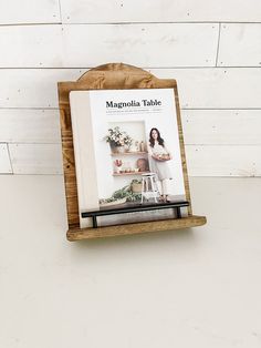 a magazine rack holding magazines on top of a table