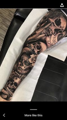 a man's arm with tattoos on it and two skulls in the middle of his arm