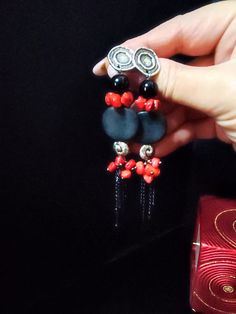 Beautiful very long earrings, created from various materials in red and black: red coral, black agate, resin elements, aluminum chain. The earrings are important and eye-catching, but at the same time they are light and comfortable to wear. The contrast between black and red make these earrings very elegant, very beautiful in summer with a low-cut dress. They recall the sea, the sun... for those who love nature. A beautiful gift for her. All jewels are delivered in a decorated box, ready to be given as a gift to your loved one. How to take care of your jewellery: put on your beauty products (cosmetics, perfumes, ...) before wearing your precious jewel. Clean your jewelry with a soft cloth after wearing. Don't use water. Make sure you store your jewelry separately to avoid scratching it. St Handmade Red Pendant Earrings, Handmade Red Long Drop Jewelry, Modern Jewelry With Dangling Beads As A Gift, Gift Black Beaded Dangle Jewelry, Gift Black Dangle Beads Jewelry, Black Party Jewelry With Unique Variations, Red Natural Stone Drop Earrings, Red Natural Stones Drop Earrings, Red And Black Beaded Drop Earrings