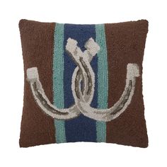 a brown and blue pillow with an anchor on it