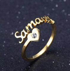 "Description:-  It will make you exciting to see your or your loved once name on this jewelry. Material: Stainless steel Plating: 18K Silver or Gold or Rose Gold Ring Size:- 7, 8, 9, 10 GEM:- Cubic Zirconia If you want Solid Rose gold, Gold or Yellow Gold, let us know we can also make that for you on request.  → [How to process the order] 1. Please tell us the name and Font Number in the 'Personalization Box' Above For Example- Jennifer + Font 1 Note: if you do not choose a font, we will make font#2 for you. and select the finish, Size, etc from the menu option. 2. Now, click on \"Pay with Paypal\" OR \"Add to basket\" . At the checkout page, you can choose to either pay with your PayPal account or you can pay with a \"credit/debit card\". 3.If you have a special request like a gift messag Personalized Heart-shaped Promise Ring, Personalized Heart-shaped Engraved Promise Ring, Personalized Engraved Heart Ring For Promise, Personalized Gold Stainless Steel Rings, Heart-shaped Rings For Valentine's Day Personalized Gift, Personalized Heart Rings For Valentine's Day, Personalized Heart-shaped Rings For Valentine's Day, Stainless Steel Promise Rings For Valentine's Day, Personalized Heart Ring For Promise