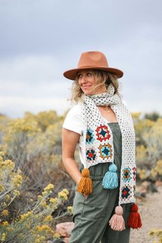 a woman wearing overalls and a brown hat