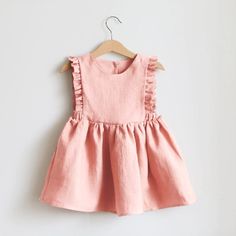 Dress your little princess in pretty pink perfection! Our Solid Linen Cotton Ruffle Dress is the epitome of summer charm. She will truly feel like a real princess! 🌸✨ Shop Here #ryanandremi #kidsfashion #babystore #childrensclothing #fashionforkids #kidsstyle #summerfrocks #summerdresses #summerdressesforkids #kidssummerdresses #cuteoutfits #kidsapparel #toddlerfashion #kidsootd #minifashion #childswardrobe #stylishkids #fashionablekids #playtimestyle #casualkids #colorfulchoices Baby Princess Dress, Girls Pinafore Dress, Girls Pinafore, Girls Smock, Striped Dress Summer, Fairytale Dress, Girls Dresses Summer, Pinafore Dress, Toddler Girl Dresses