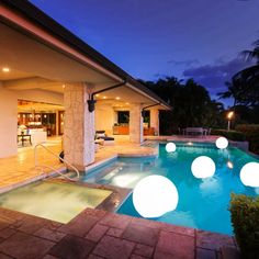 an outdoor pool with lights around it