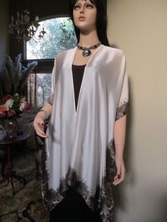 Elegant, white silk kimono with a subtle, animal print border in a soft gray/black color. A versatile top to wear with pants, skirts or as a beach coverup, from dressy to casual. Also comes in black. One size. Fits small to large. The width is 34 inches when closed, 68 inches around the body. The length is 34 inches. Can be hand washed or dry cleaned. Summer Kimono, Pants Skirts, Silk Kaftan, Silk Dress Long, Silk Shawl, Womens Kimono, Long Kimono, Silk Jacket, Silk Wrap