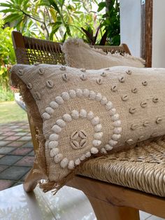 two pillows sitting on top of a wooden bench