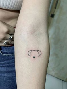 a woman's arm with a small elephant tattoo on the left side of her arm