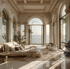 a large living room with lots of windows and white furniture on the floor next to an ocean view