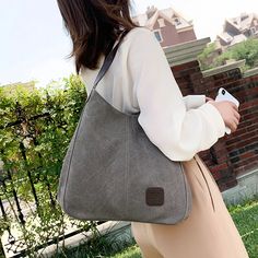 SPECIFICATIONSBrand Name: YogodlnsHandbags Type: Shoulder BagsTypes of bags: Shoulder & HandbagsMain Material: CanvasLining Material: PolyesterShape: Casual TotePlace Of Origin: ZHE JIANG ProvincePlace Of Origin: GUANG DONG ProvinceOrigin: Mainland ChinaCN: GuangdongHardness: SOFTPattern Type: SolidInterior: Interior CompartmentDecoration: NONEExterior: NONEOccasion: VersatileClosure Type: zipperGender: WOMENStyle: fashionNumber of Handles/Straps: SingleHandle Bag: Fashion Handle BagBaguette Bag: France Baguette BagShoulder Bag: Large Capacity Shoulder BagHandbag: Casual Canvas HandbagWomen Bag: Vintage Hot Lady Shopping HandbagChoice: yessemi_Choice: yes Handheld Canvas Shoulder Bag For Shopping, Large Capacity Handheld Canvas Bag, Trendy Canvas Hobo Bag For Errands, Handheld Canvas Shoulder Bag For Errands, Large Capacity Canvas Hobo Shoulder Bag, Gray Large Capacity Satchel Canvas Bag, Gray Large Capacity Satchel Bag, Casual Top Handle Canvas Bag, Trendy Gray Tote Bag