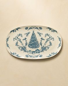 a blue and white plate with a christmas tree on it